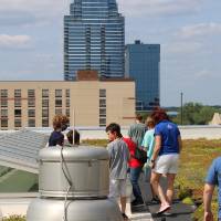 Students explore around the skylight on the rooftop garden
